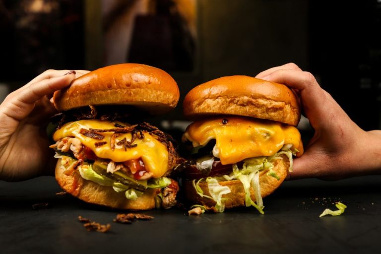 front view woman eating meat burgers 1024x683 1 768x512